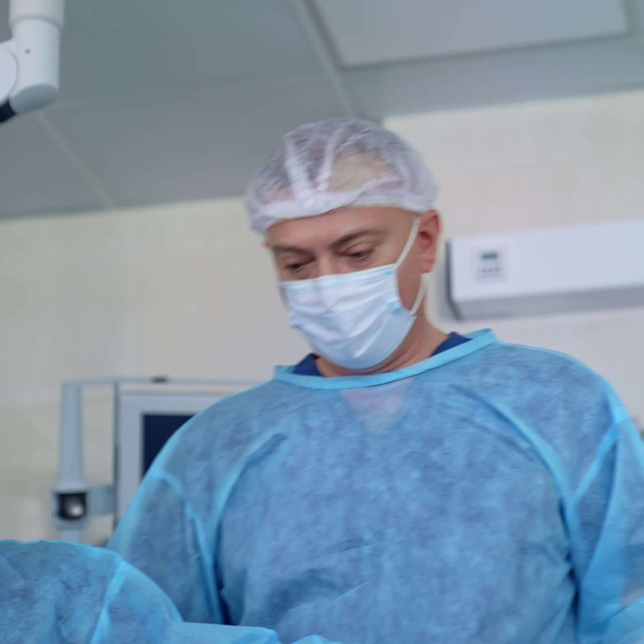 Surgical operation by specialists. Teamwork of doctors in medical uniform performing a surgery in modern operating room