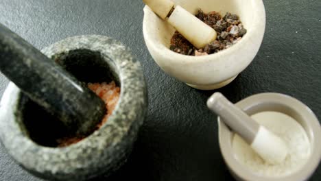 sea salt and black salt in mortar pestle 4k