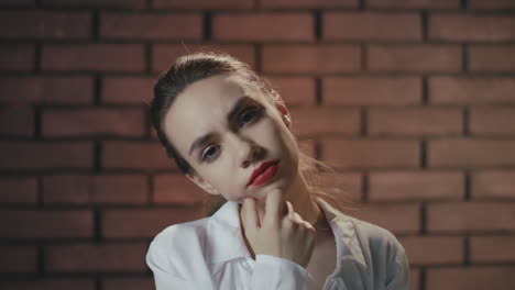 Pensive-woman-thinking-ideas-posing-on-brick-wall-background