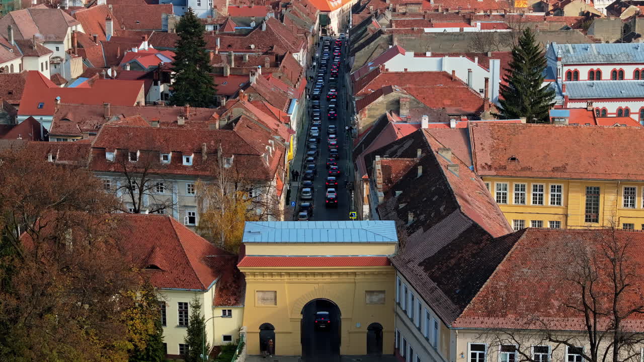 Aerial drone view of cars passing under the Schei Gate in Brasov, Romania