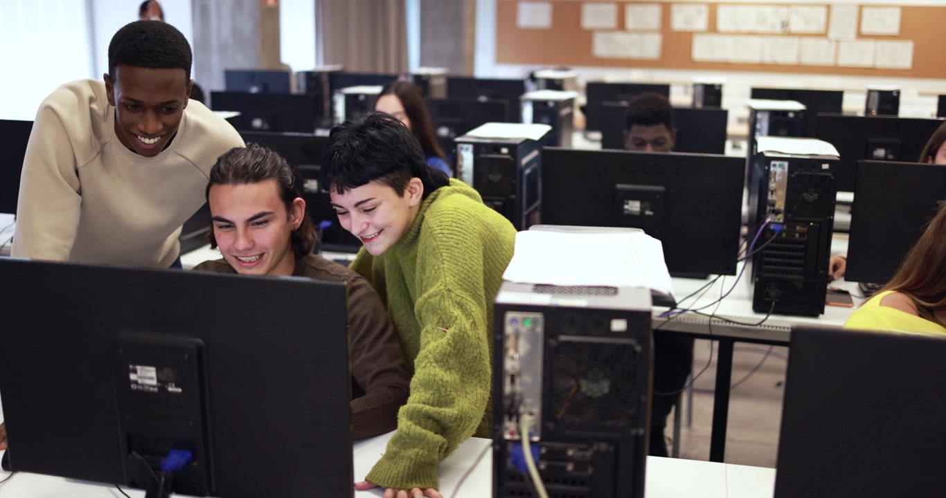Diverse Students Collaborating on Computer in University Lab