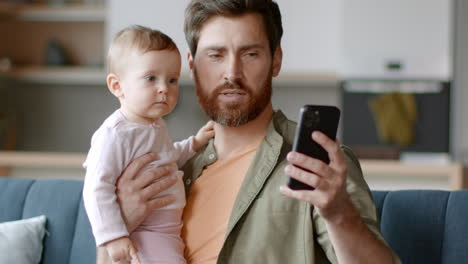father and baby daughter on couch