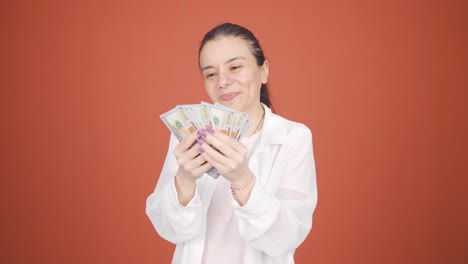 woman counting money looking at camera.