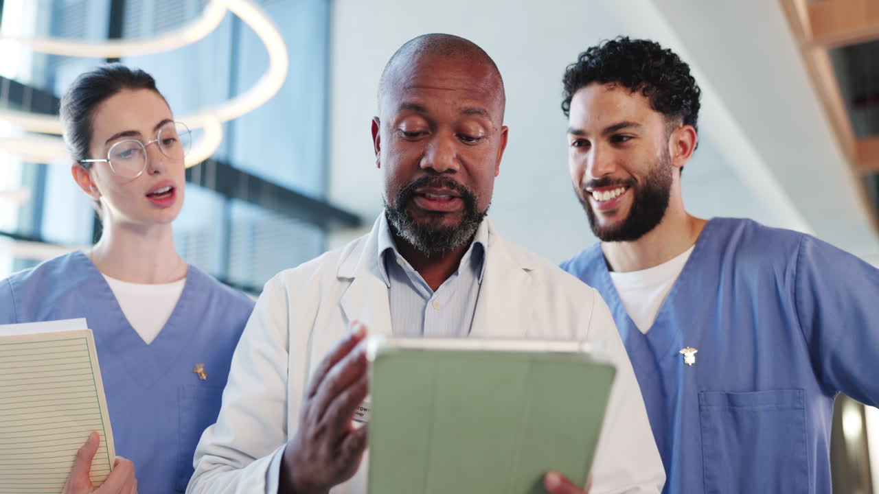 Doctor and Nurses Reviewing Data on a Tablet in a Modern Hospital
