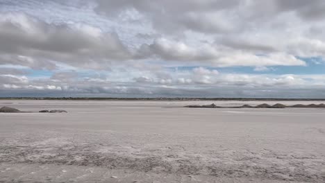 salt flat landscape from a car window, in a cloudy sky