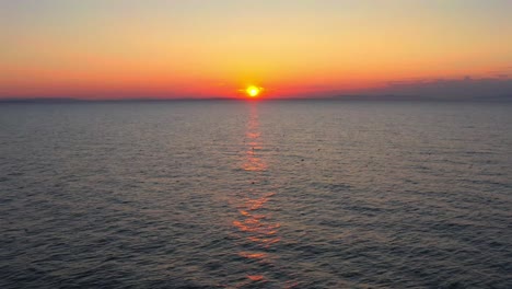 Luftaufnahme-Eines-Vogelschwarms-Und-Sonnenuntergang-An-Der-Nordsee-Am-Findhorn-Beach,-Schottland