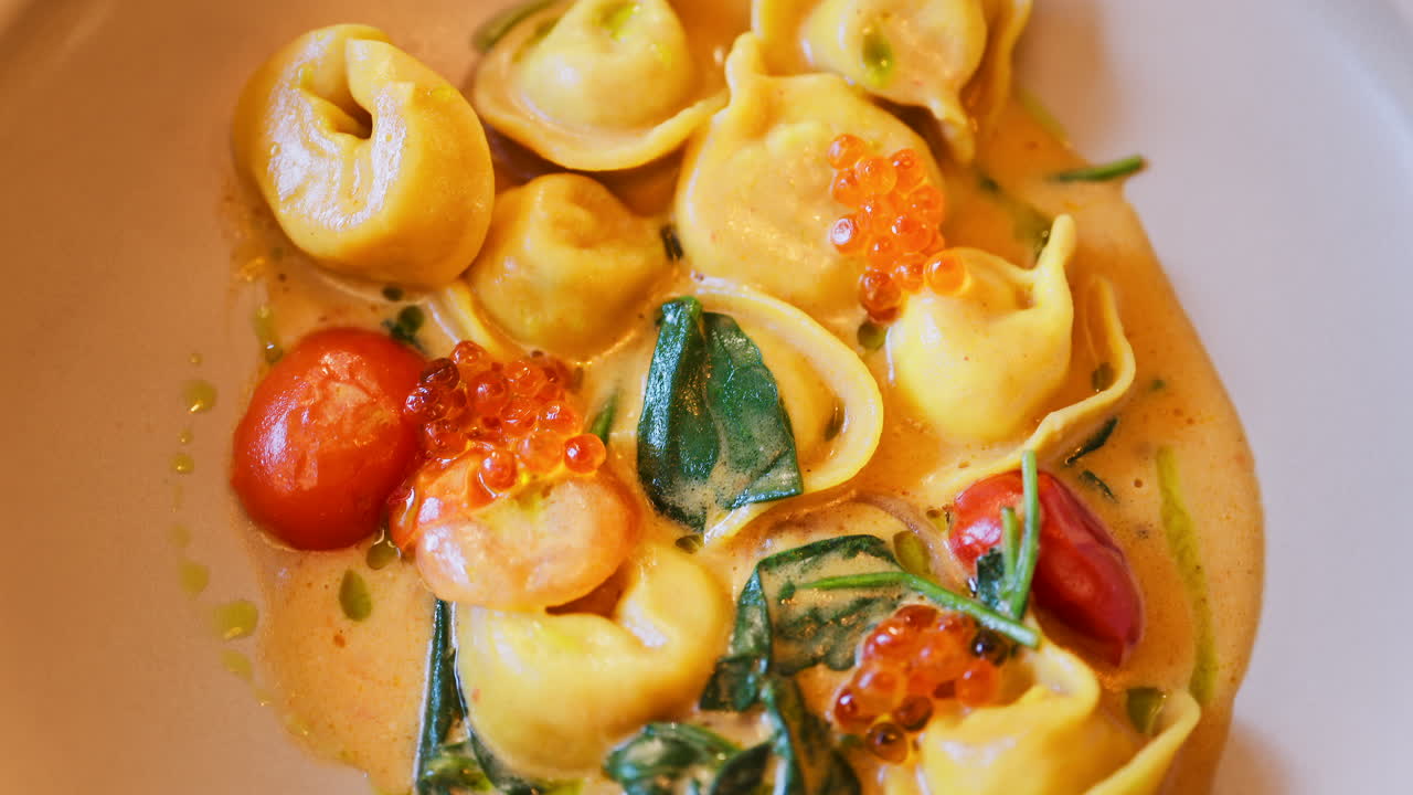 Close up of a ravioli dish with seafood and sauce at a restaurant