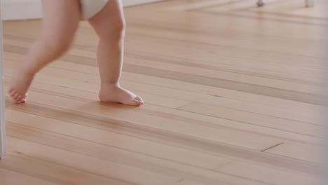 clsoe-up-feet-baby-learning-to-walk-toddler-exploring-at-home-curious-infant-walking-through-house-enjoying-childhood