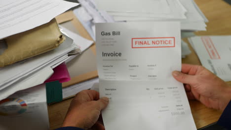 close up of a man opening debt letters