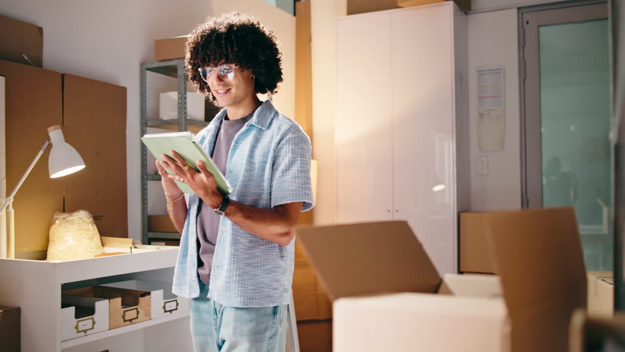 Young Man Managing E-commerce Inventory with Digital Tablet