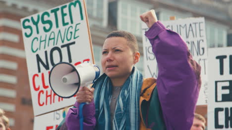 group of protestors with placards and megaphone on demonstration march against climate change