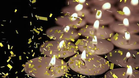 Animation-of-gold-confetti-falling-over-lit-tea-light-candles-on-black-background