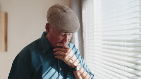 senior man, thinking and window in house