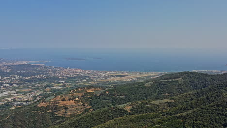 Tanneron-France-Aerial-v22-high-angle-drone-descent-shot-capturing-beautiful-coastal-seascape-of-mediterranean-sea-and-overlooking-at-village-settlements-and-mountain-terrain---July-2021