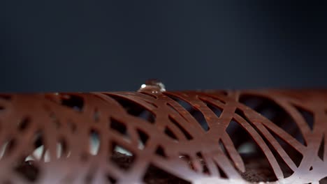 a person decorated a chocolate with a gold paper, close up shot, insert shot