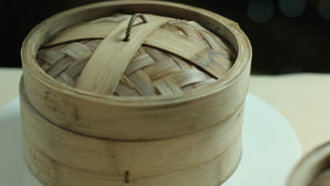 opening the wooden steamers with chinese dumplings