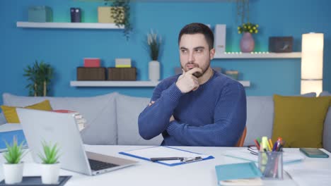 Home office working man thinks and doesn&#039;t like the idea that comes to his mind.