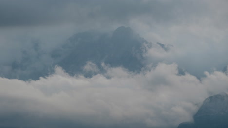 timelapse of thick clouds engulfing a mountain range