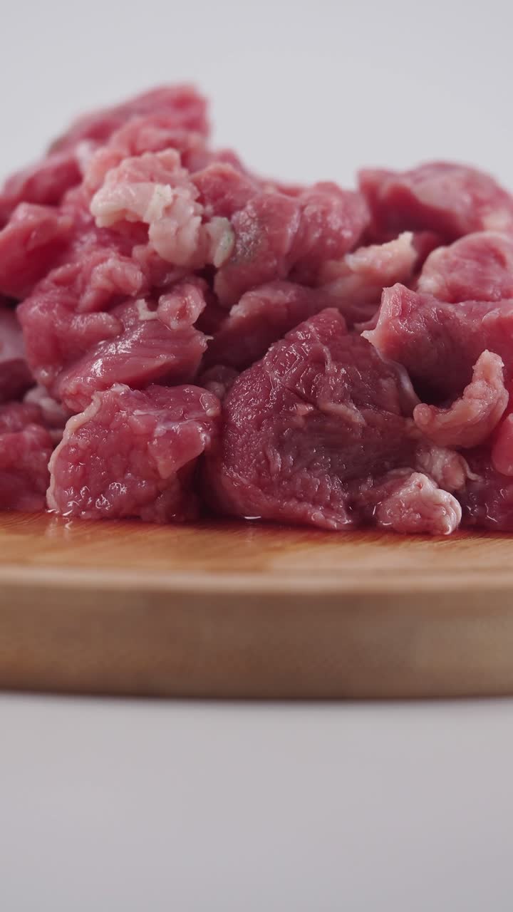 Daging Potong Dadu Mentah di Atas Talenan Kayu