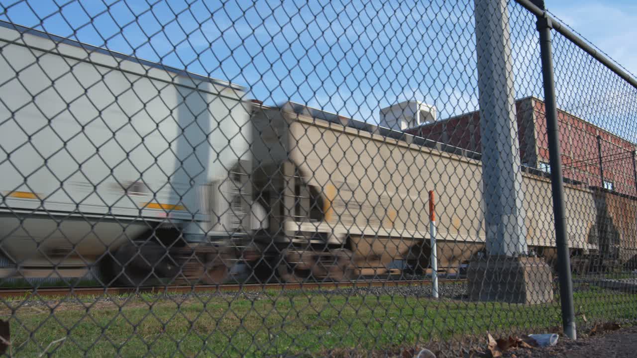 Establishing shot train on train tracks moving cargo