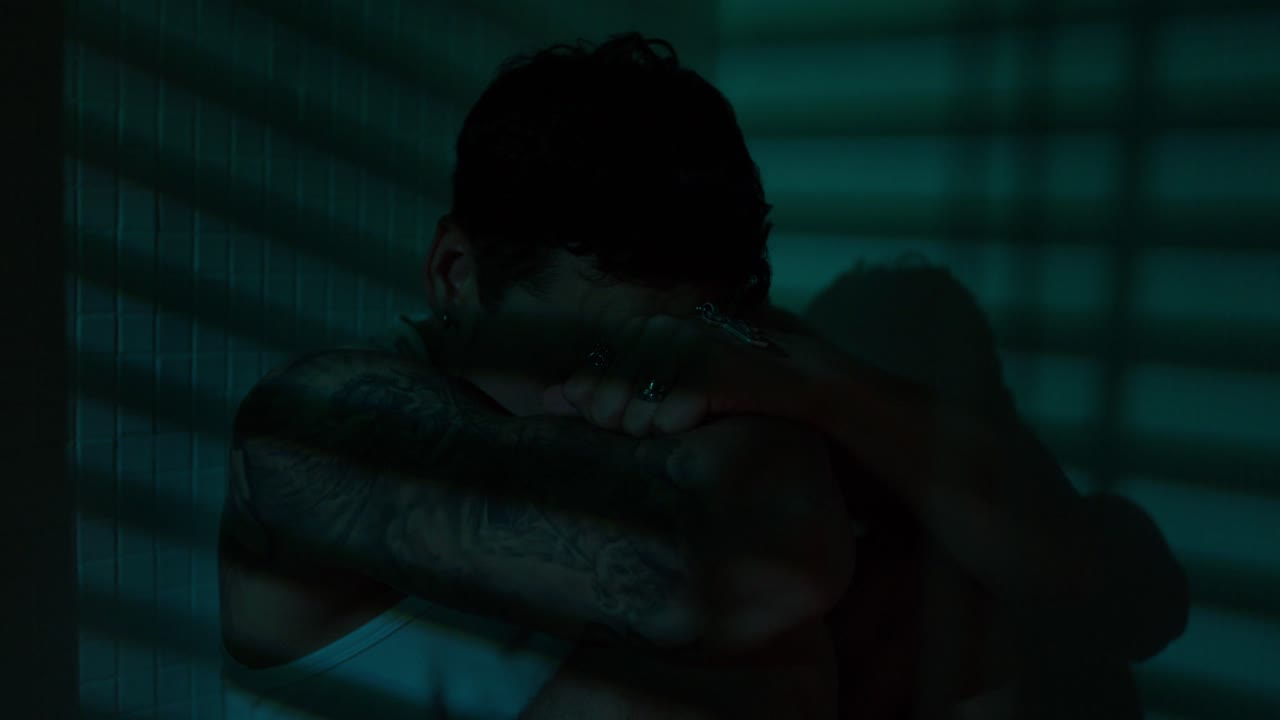 Man in shadow expressing sadness