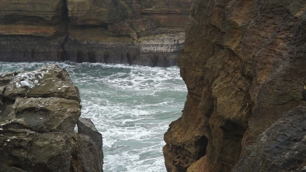 Tidal ocean waves hitting Punakaiki Pancake Rocks, New Zealand