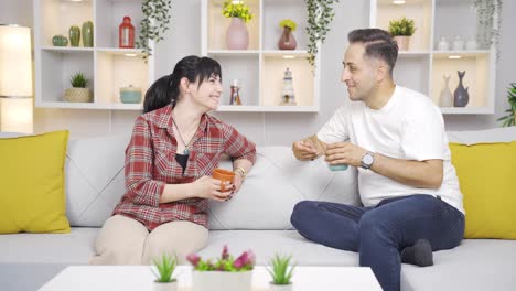 happy couple enjoying coffee at home.