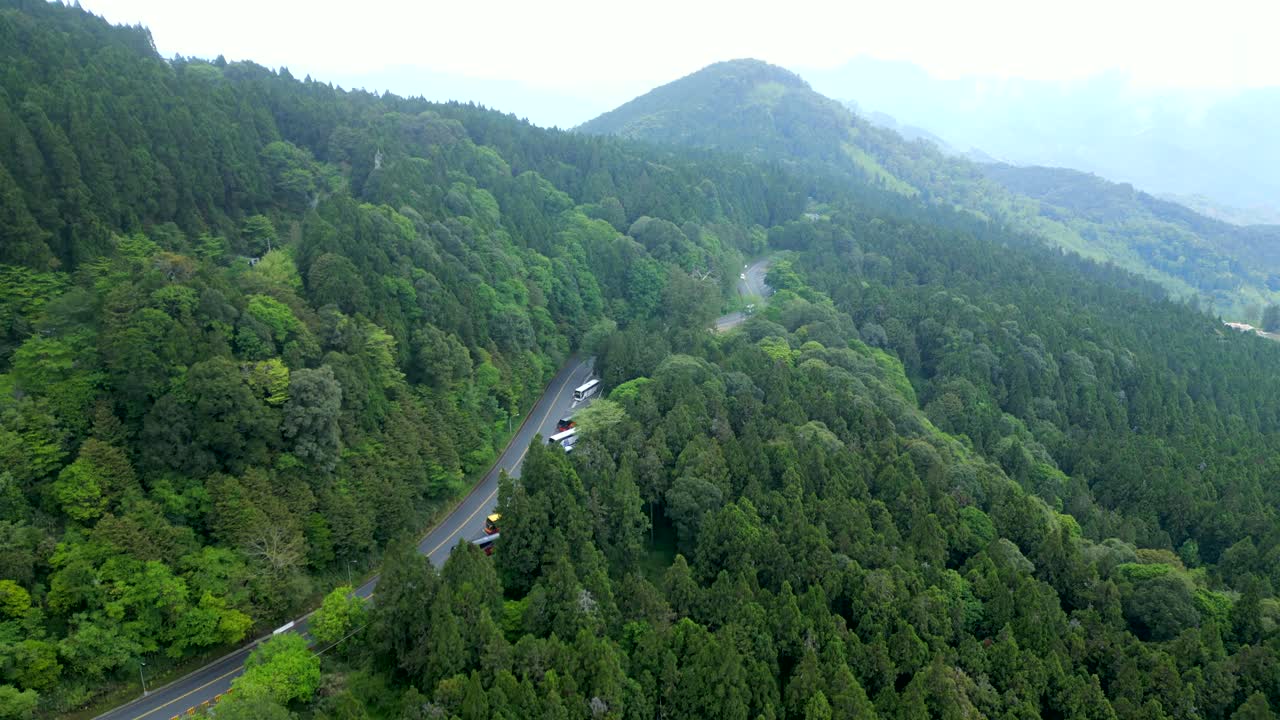 Scenic Road Winding Through Lush Forested Mountains Of Alishan In Mist. Alishan National Forest Recreation Area In Chiayi County, Taiwan. aerial ascend