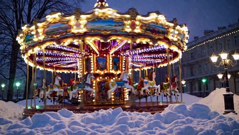 A low-angle video captures a brightly lit carousel in a snowy park at dusk, showcasing a nostalgic