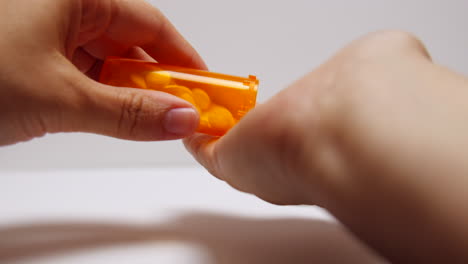 pills pour out onto addict's hand