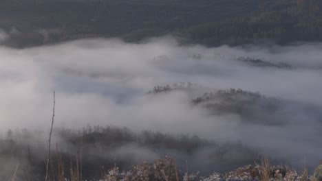 wide angle shot of low-lying mist in a valley in the scottish highlands