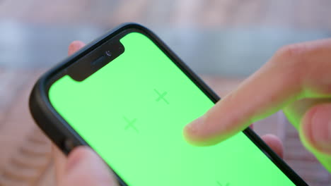 Primer-Plano-De-La-Parte-Superior-De-La-Pantalla-Del-IPhone-Que-Se-Toca-Y-Desliza,-Con-Una-Pantalla-Verde-Para-Reemplazar