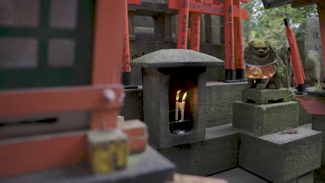 candles burning at fushimi-inari taisha, kyoto japan