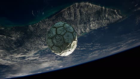 old soccer ball in space on earth orbit