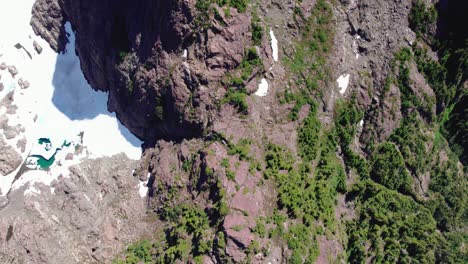 Aerial-Dropping-Shot-Glacial-Lake-Mountain-Summit---Mackenzie-Range,-Vancouver-Island,-BC,-Canada