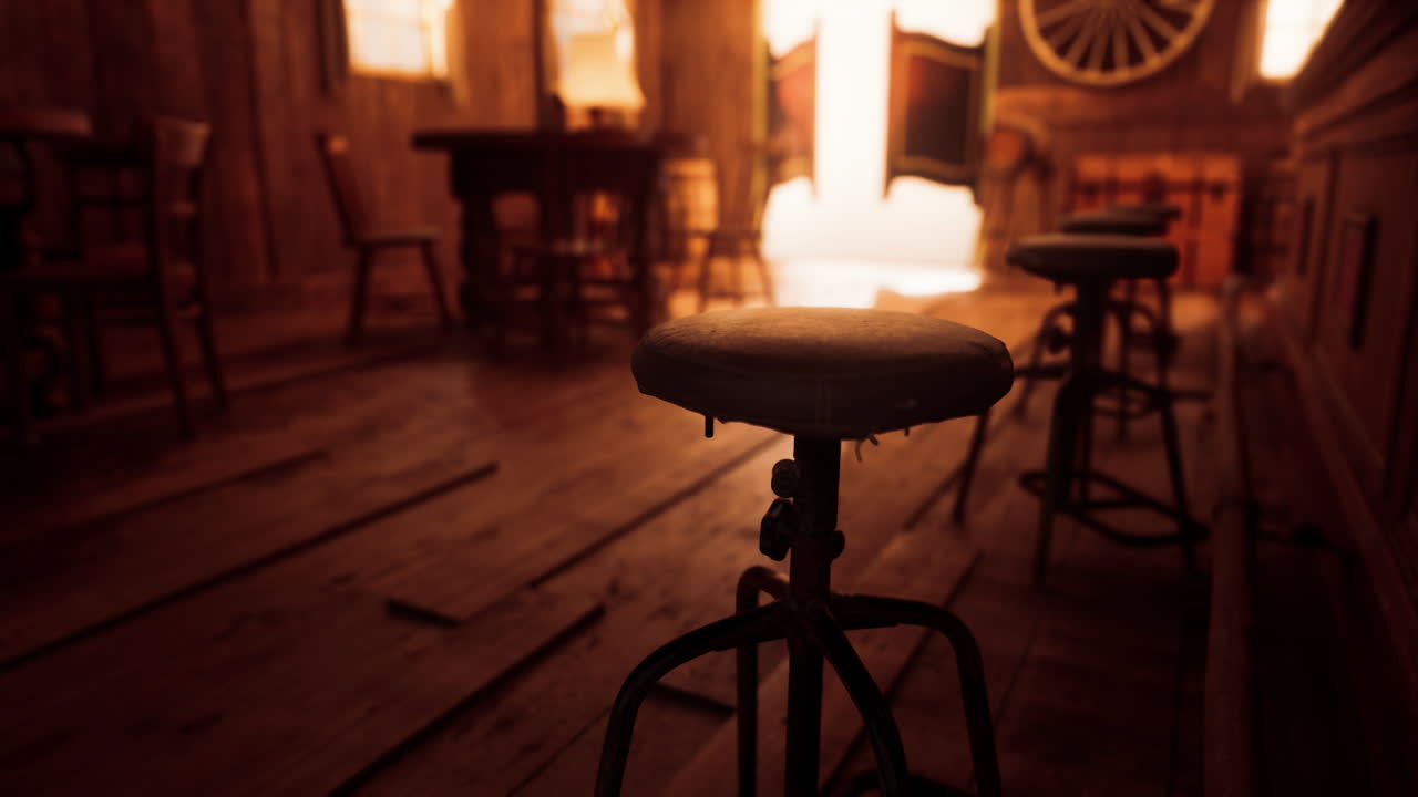 Interior of an old saloon with wooden stools and rustic decor at sunset