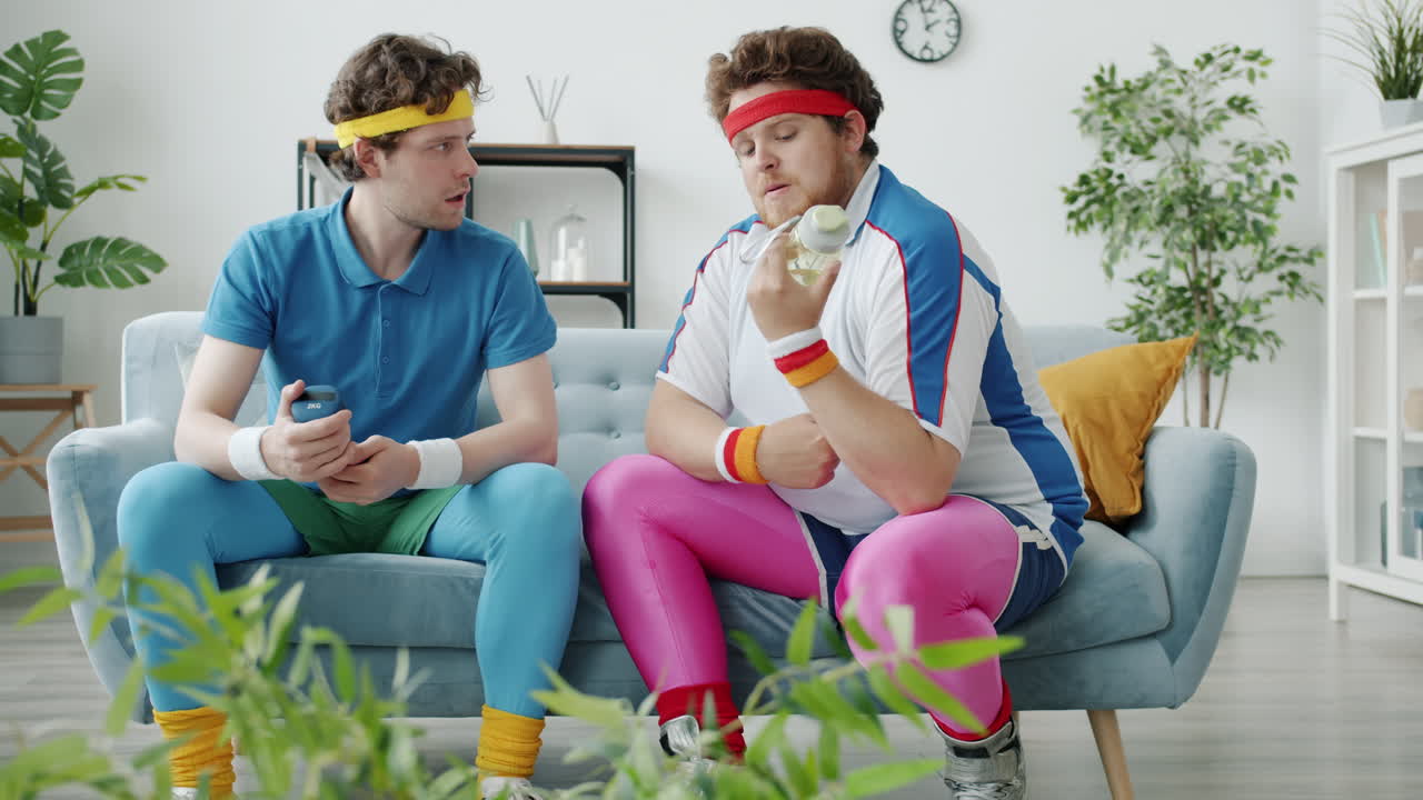 Two friends having a funny workout session at home