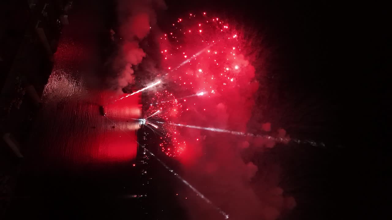 Continuous discharge vertical view of the New Year's Eve fireworks show on the Chilean coastline - Valparaiso at night