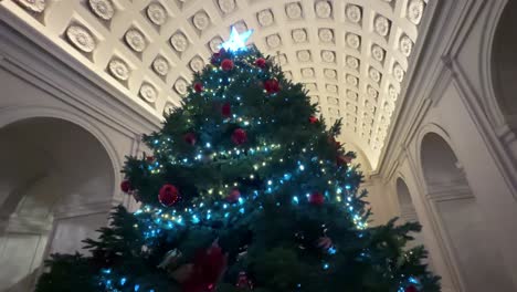 slow parallax shot around large festive christmas inside pasadena city hall