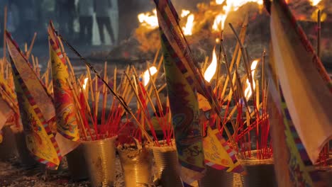 traditional chinese funeral ceremony with burning paper flags and offerings