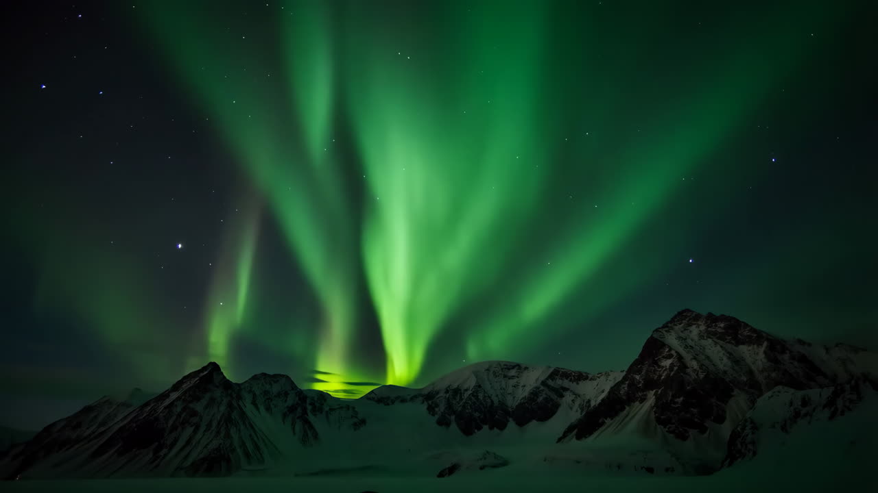 Vibrant Aurora Borealis over Snow-Capped Mountains at Night