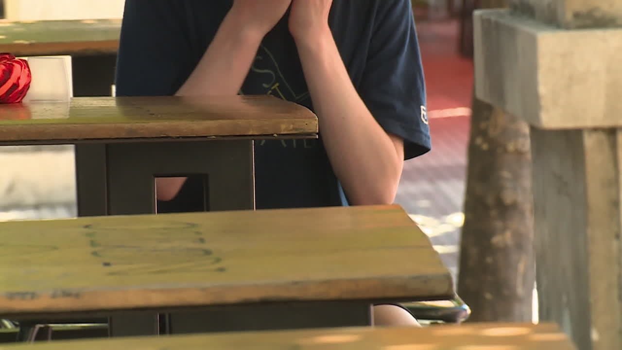 Boy clapping at outdoor table