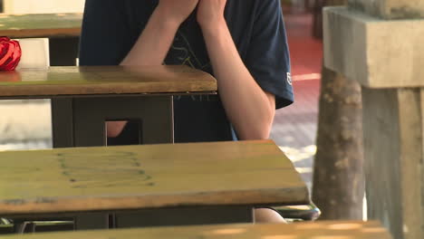 boy clapping at outdoor table