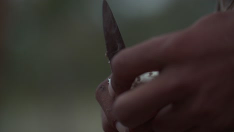 close-up of hands peeling a root vegetable with a knife