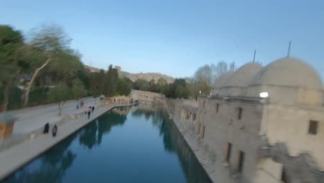 advancing aerial drone footage extreme fast flying around sheyh ali dede turbesi, near the urfa in sanliurfa city, turkey. exiting footage shot with fpv racing drone aerobatic