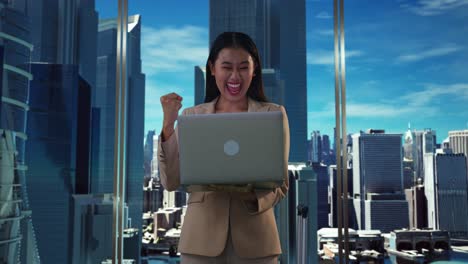 excited businesswoman with laptop