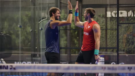 padel players celebrating and shaking hands on court