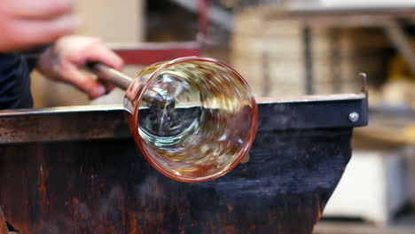 glassblower shaping a molten glass