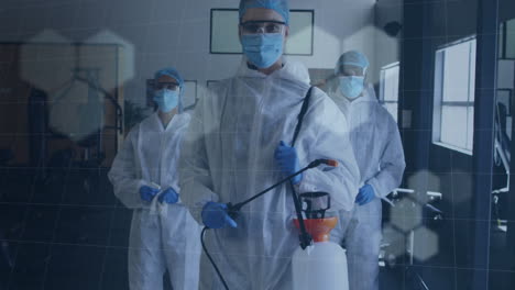 sanitation team members spraying disinfectant wand in gym, showing digital grid hexagon overlay