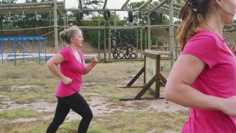 Female-friends-enjoying-exercising-at-boot-camp-together